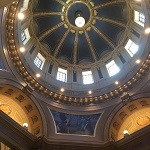 The Chandelier is lit in the dome of the State Capitol dome.