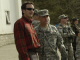 Governor Pawlenty speaks with Lt. Col. Mike Funk, from Olivia, Minn., in Kosovo.  Lt. Col. Funk lead...