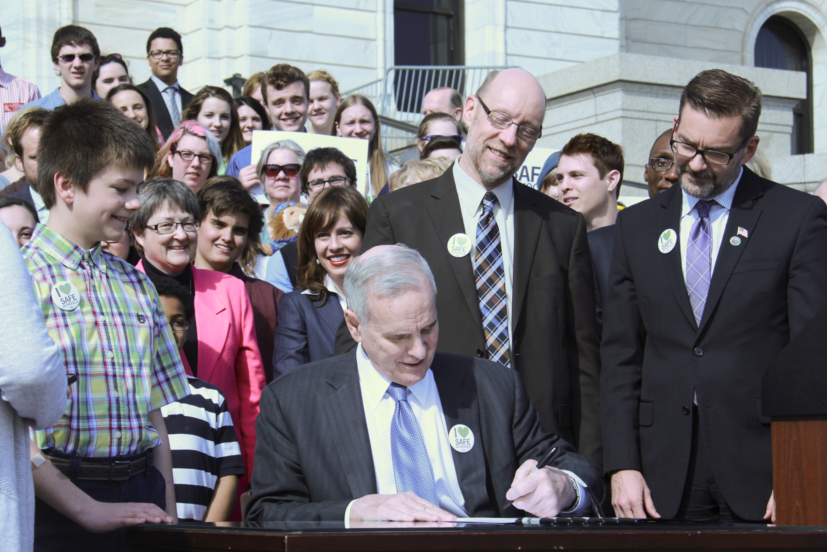Surrounded by students, parents, teachers, and school administrators, Governor Mark Dayton today signed the Safe and Supportive Schools Act