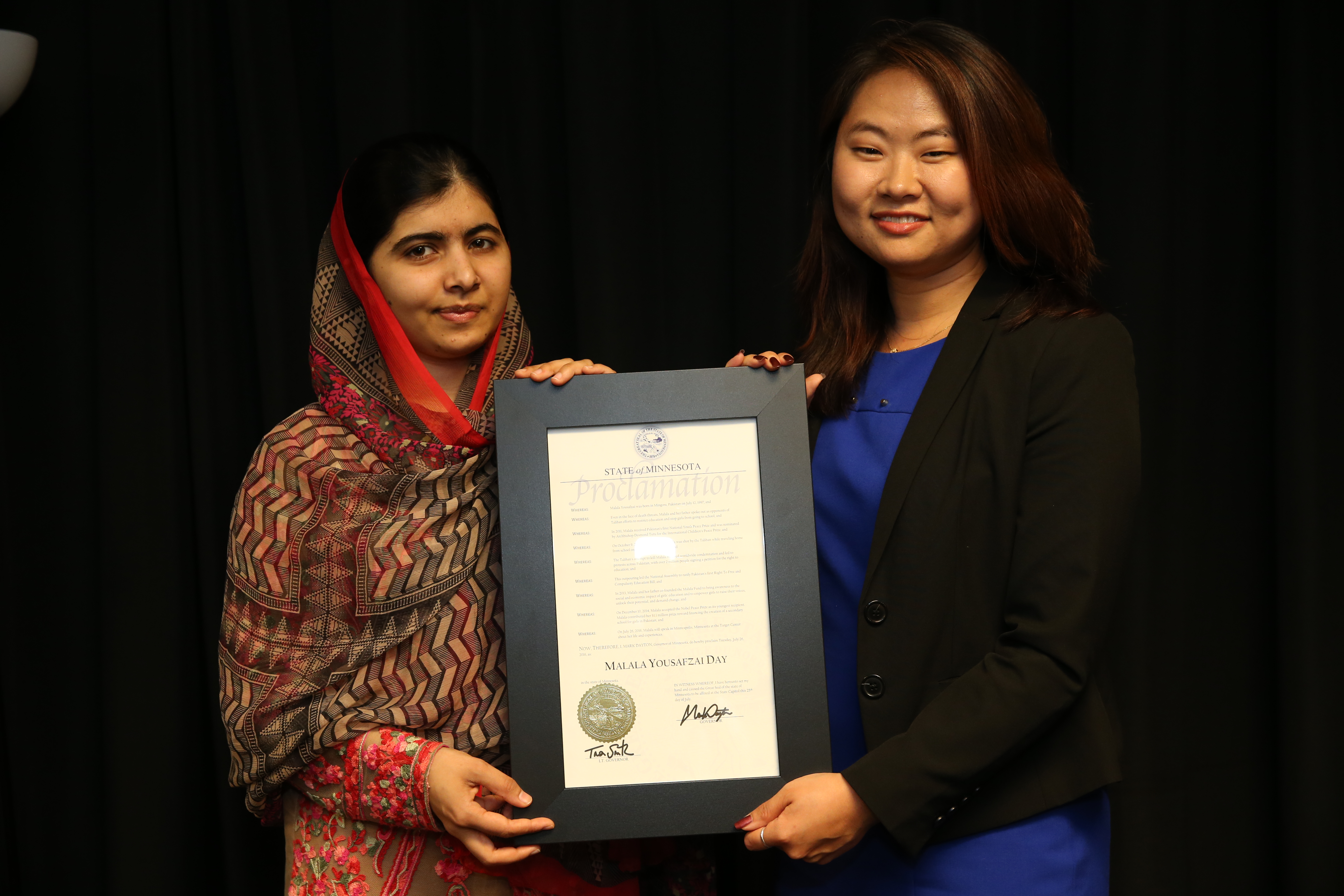Malala Yousafzai and Constituent Outreach Liaison Sumee Lee stand with the proclamation proclaiming Malala Yousafzai Day in Minnesota